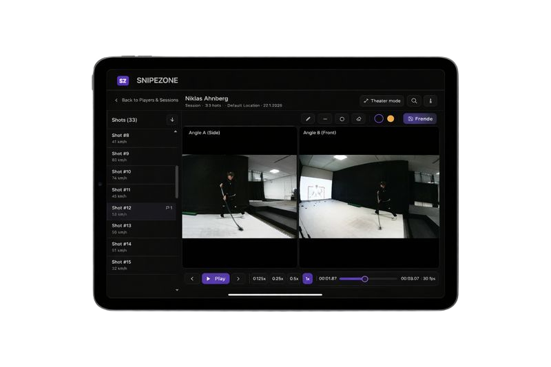Hockey coach analyzing team performance data and monitoring players using the SnipeZone Coach’s App dashboard on a tablet.